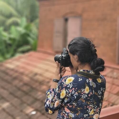 A guest taking photos of Kerala achitecture during photography tour